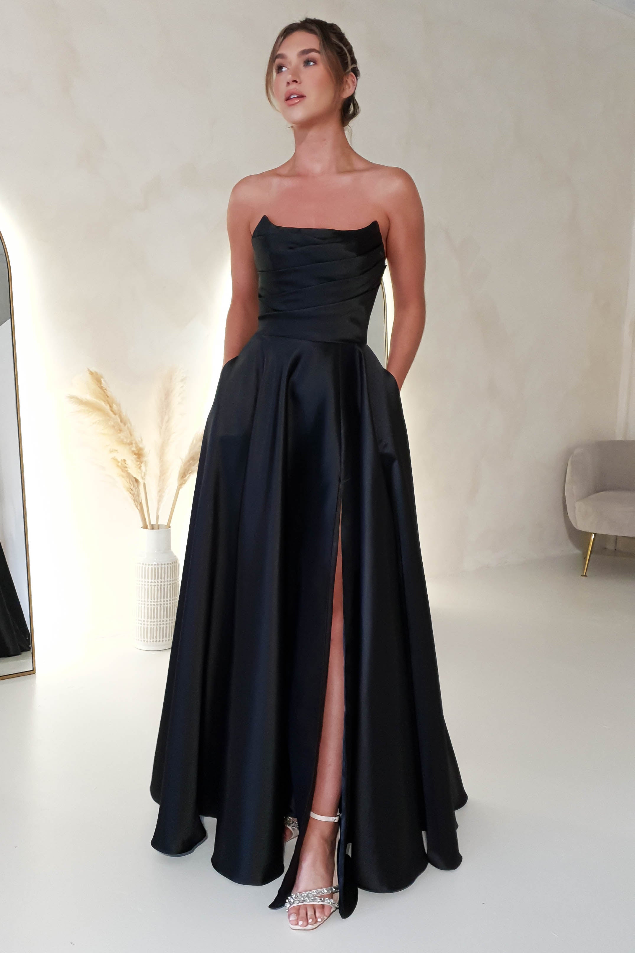 Our Oh Hello Clothing Model wearing a  A-Line Satin Black Tie Gown with pockets
